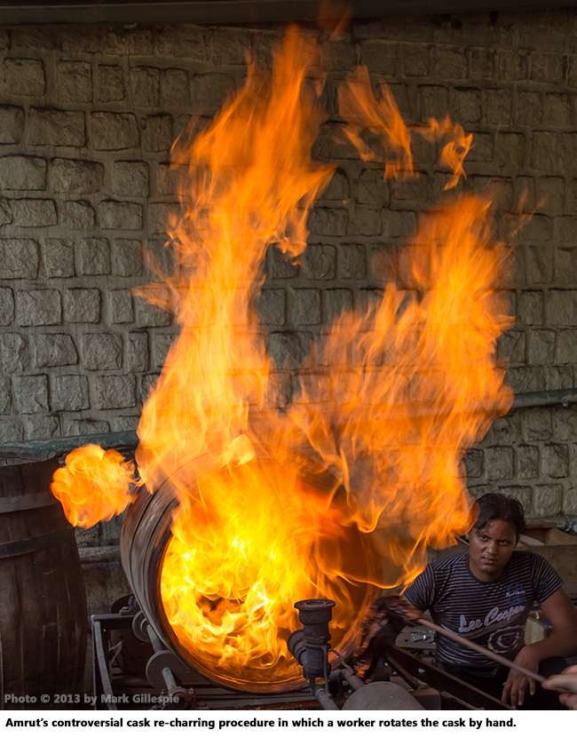 The controversial cask re-charring procedure at Amrut in which a worker rotates the cask. 