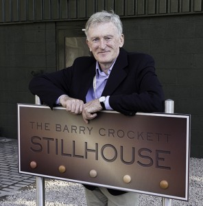 Retiring Irish Distillers Master Distiller Barry Crockett with the sign dedicating the Midleton still house in his honor on September 4, 2013. Image © 2013 by Mark Gillespie.