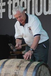 Ger Buckley, Midleton Distillery's 5th generation cooper, demonstrates the breaking down of a barrel during The Housewarming celebration at Midleton September 4, 2013. Image ©2013 by Mark Gillespie. 