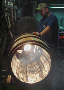 An Independent Stave Company cooper inspects a Bourbon barrel at the company's Lebanon, KY cooperage in this 2008 file photo. Photo ©2008 by Mark Gillespie.