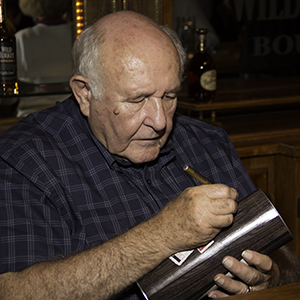 Wild Turkey Master Distiller Jimmy Russell signs a Redemption canister during the Kentucky Bourbon Festival on September 18, 2013. Photo ©2013 by Mark Gillespie. 