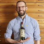 Illustrator Dermot Flynn with the 2014 Jameson St. Patrick's Day bottle. Image courtesy Irish Distillers. 