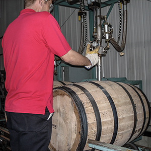 A Maker's Mark Distillery worker fills a new barrel with "white dog" spirit. Photo ©2008 by Mark Gillespie.