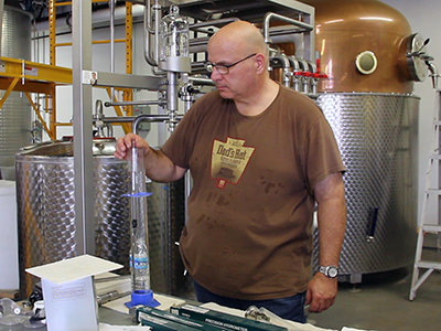 Dad's Hat co-founder Herman Mihalich tests a spirit run at the distillery on August 23, 2013. Image ©2013 by Mark Gillespie. 