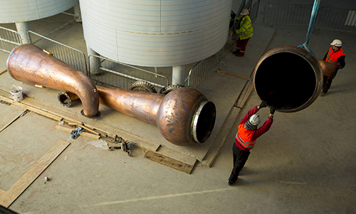 Workers install the pot stills at the new Tullamore D.E.W. Distillery in Tullamore, Ireland. Photo courtesy William Grant & Sons. 