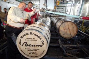 Fred Noe and his son, Freddie Noe, hammer in the bung on Beam's 13 millionth barrel of whiskey since the end of Prohibition in 1933 during a ceremony in Clermont, Kentucky. Photo courtesy Beam.