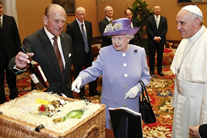 Prince Philip displays a bottle of Balmoral Scotch Whisky distilled at Royal Lochnagar Distillery as Queen Elizabeth presents a gift basket to Pope Francis at the Vatican on April 3, 2014. Reuters Photo by Stefano Rellandini.