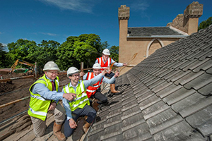 Wemyss Malts owner William Wemyss (at rear) toasts the completion of the roof at Kingsbarns Distillery with Doug Clement, distillery manager Peter Holroyd, and construction manager Ian Bownes. Photo by Douglas Robertson courtesy Wemyss Malts. 