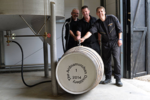 Ardnamurchan manager Graeme Bowie (center) fills the distillery's first cask with Gordon MacKenzie (L) and Mark Armin Giesler (R). Photo courtesy Adelphi Distillery Ltd.  