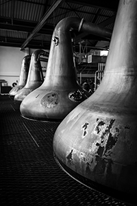 The stills at Aultmore Distillery in Scotland. Photo ©2014 by Mark Gillespie.