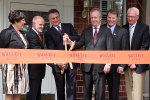 Diageo North America President Larry Schwartz cuts the ceremonial ribbon to open the Bulleit Frontier Whiskey Experience at the Stitzel-Weller Distillery in Louisville September 15, 2014. Photo ©2014 by Mark Gillespie.