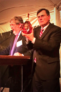 DISCUS President & CEO Adm. Peter Cressy holds the Bill Clinton-signed bottle of George Washington's Rye during the Spirit of Mount Vernon auction October 14, 2014. Photo courtesy DISCUS.