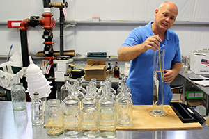 Steve Beam uses a hydrometer to check the strength of his spirit at Limestone Branch Distillery in September, 2012. Photo ©2012 by Mark Gillespie. 