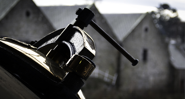 A still and warehouses at Royal Brackla Distillery in Scotland. Photo ©2014 by Mark Gillespie