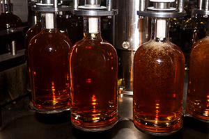 Whisky bottles being filled on the bottling line at Bruichladdich Distillery in September, 2011. Photo ©2011 by Mark Gillespie.