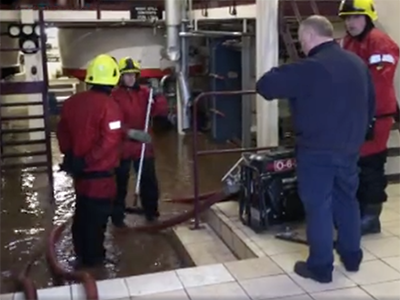 Glencadam Distillery manager Douglas Fitchett and firefighters look over flooding in the still house on January 7, 2016. Photo courtesy STV News.