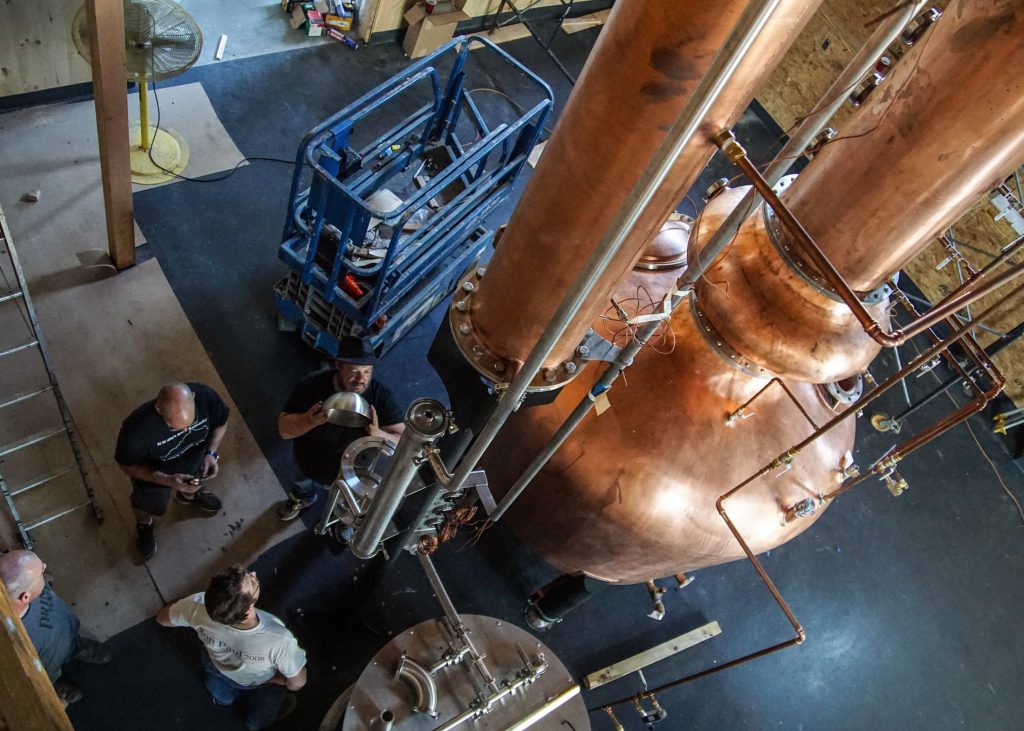 WhistlePig Master Distiller Dave Pickerell (with hat) during installation of the distillery's still in 2015. Image courtesy WhistlePig Rye.