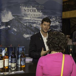 A member of Diageo's Masters of Whisky program explains Talisker to a consumer during the 2013 Whisky Live event in Boston. File Photo ©2013, Mark Gillespie/CaskStrength Media.