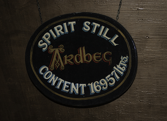 The vintage sign on Ardbeg Distillery's spirit still. Photo ©2016, Mark Gillespie, CaskStrength Media.