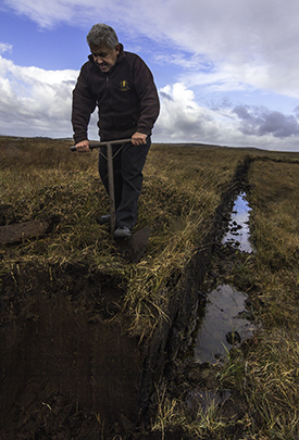 Lagavulin's Iain McArthur cutting peat at his family's bog October 18, 2016. Photo ©2016, Mark Gillespie/CaskStrength Media.