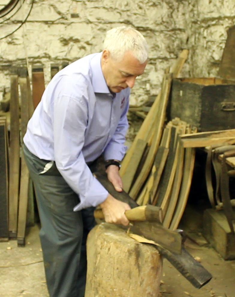 Midleton Distillery cooper Ger Buckley demonstrates the use of a vintage cooper's axe.