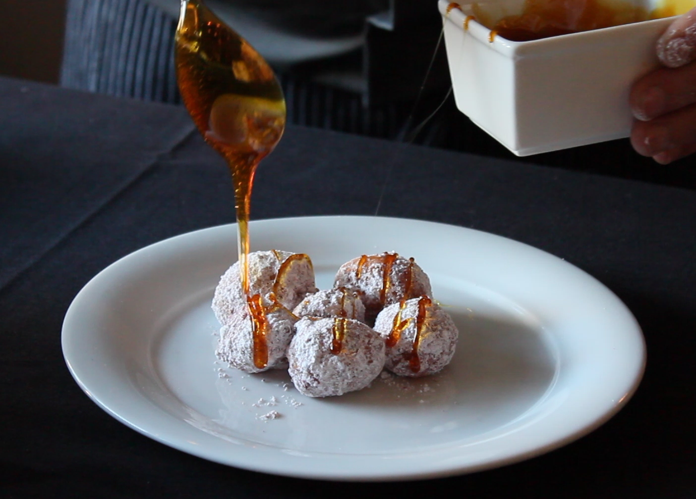 Chef Mike Isabella adds his Bourbon Caramel Sauce to his deep-fried Zeppoles.