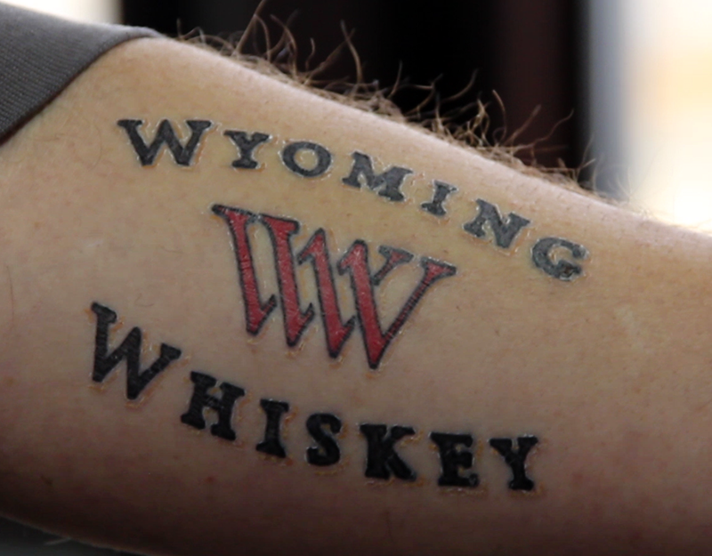 A Wyoming Whiskey tattoo on the arm of one of the distillery's stillmen.
