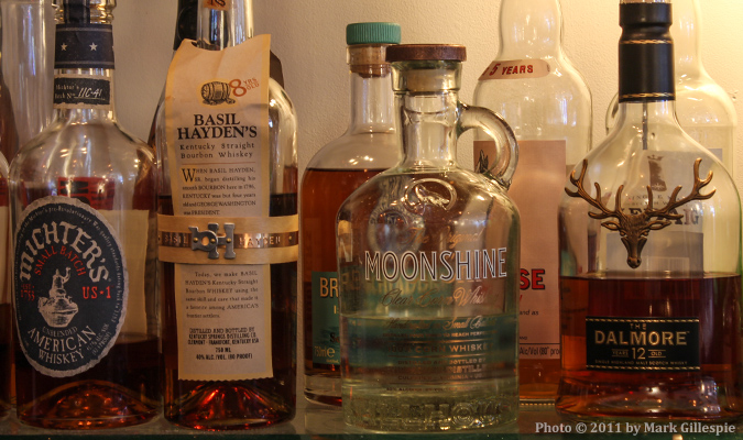 Whiskies on a bar shelf.
