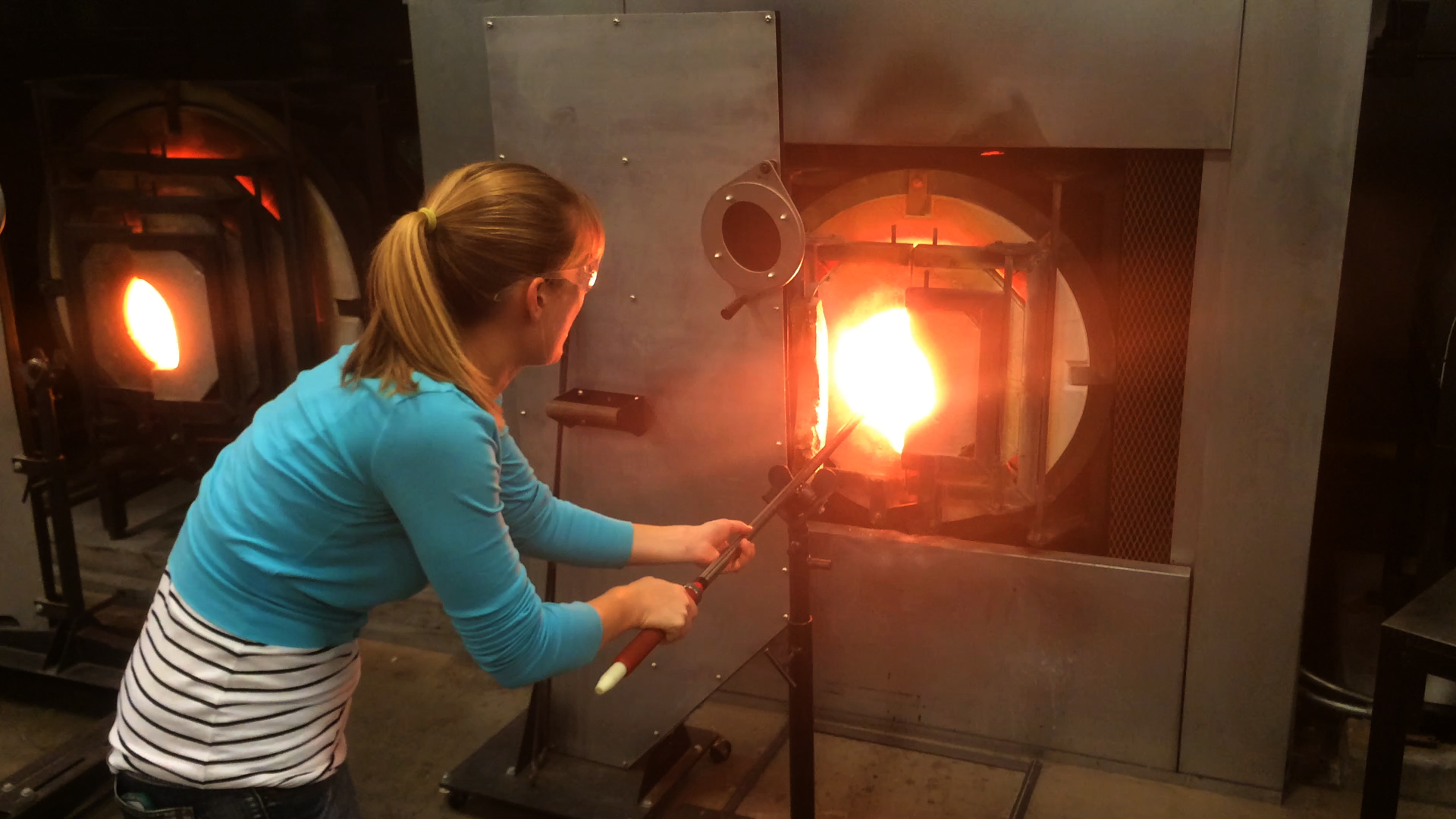 Writer Susannah Skiver Barton heats up a glass win the furnace at Brooklyn's Urban Glass on November 2, 2015. Photo ©2015 by Mark Gillespie.