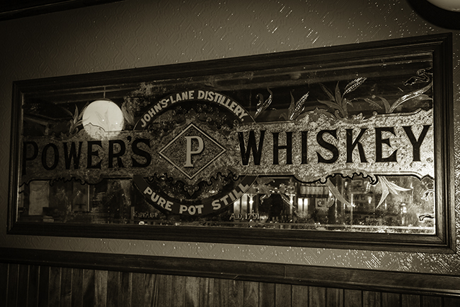 A vintage Power's Whiskey mirror on display at the Brian Boru pub in Dublin. Photo ©2011 by Mark Gillespie.