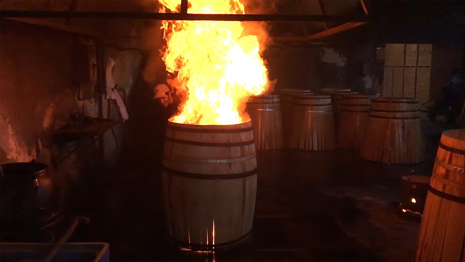 A cooper at the A. Páez Toneléria examines a cask being toasted with open flame on September 2, 2016. Photo ©2016, Mark Gillespie, CaskStrength Media.