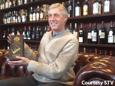 Colin Plint with the signed bottle of "Trump Scotland" whisky at McTear's January 13, 2017. Image courtesy STV.