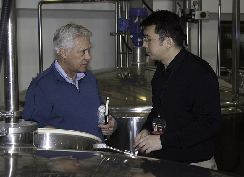Dr. Jim Swan and King Car Distillery's Ian Chang examine a fermenter at the distillery. File photo ©2011, Mark Gillespie/CaskStrength Media.