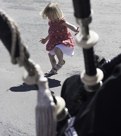 3-year-old Chloe Kelbie dances to bagpipe music at Caol Ila's festival day May 24, 2010. Photo ©2010, Mark Gillespie/CaskStrength Media.