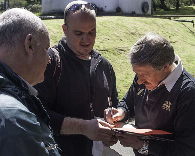 Richard Paterson (R), signs a copy of his book for Shai Gilboa (C) and Gideon Fleischmann (L) during Jura's festival day on May 27, 2010. Photo ©2010, Mark Gillespie/CaskStrength Media.