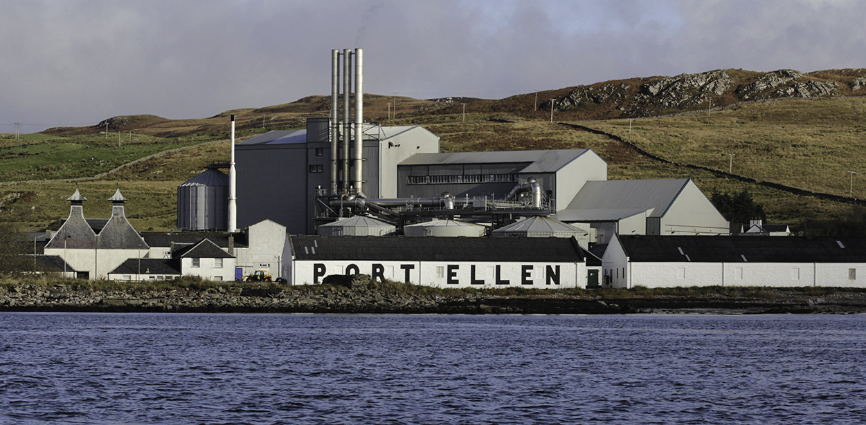 The Port Ellen Distillery and its warehouses, with Diageo's Port Ellen Maltings in the background. Photo ©2017, Mark Gillespie/CaskStrength Media.