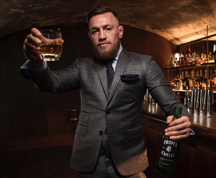 MMA champion Conor McGregor with a bottle of his Proper No. Twelve Irish Whiskey. Photo courtesy Eire Born Spirits.