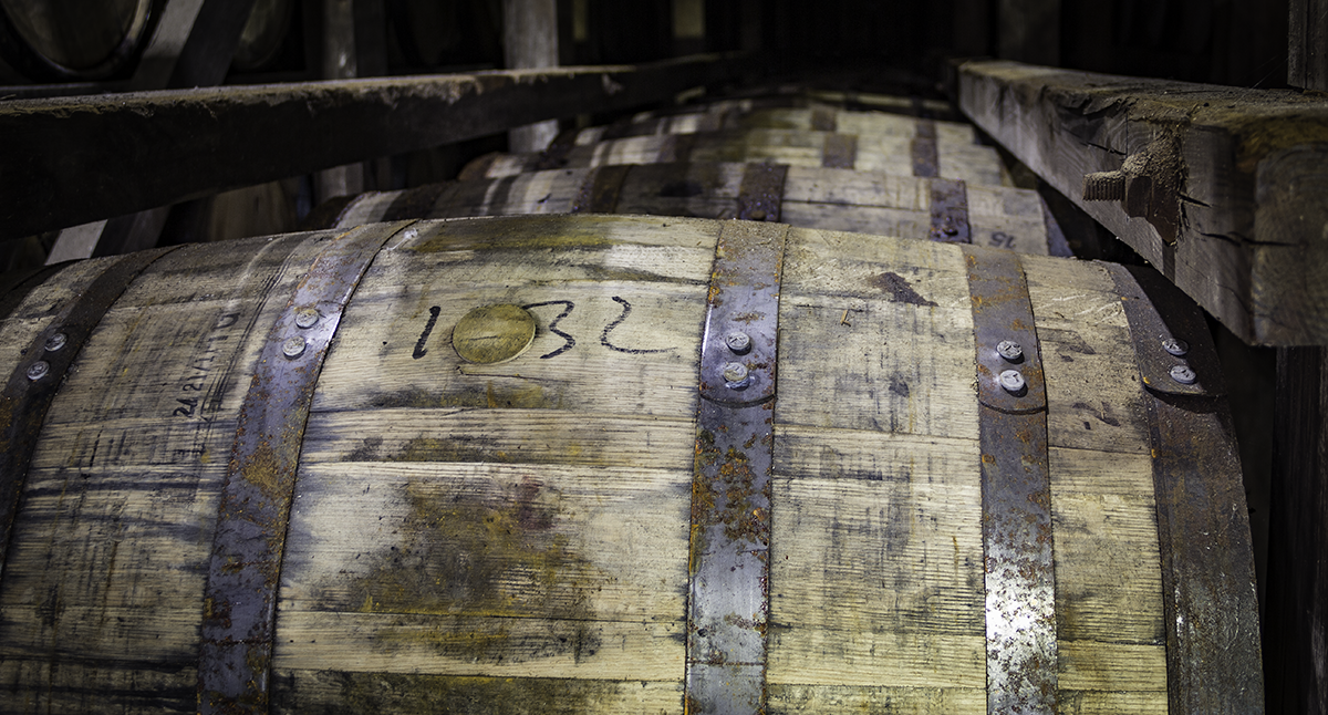 A row of Bourbon barrels in a warehouse at the Stitzel-Weller Distillery in Louisville, Kentucky. Photo ©2019, Mark Gillespie/CaskStrength Media.