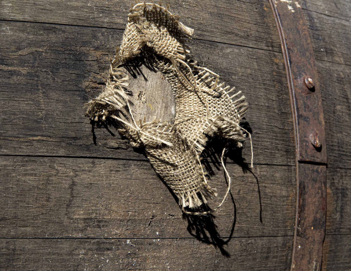 A bung tightly fitted into a whisky barrel with a piece of burlap. Photo ©2019, Mark Gillespie/CaskStrength Media.