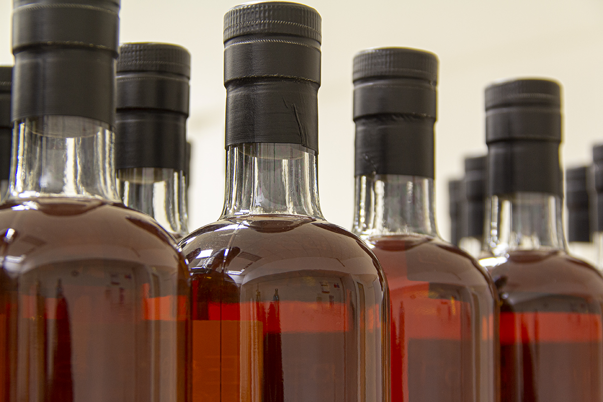 Bottles of Scotch Whisky on a bottling line before labeling. File photo ©2019, Mark Gillespie/CaskStrength Media.