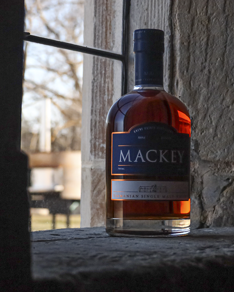 <em>Mackey Tasmanian Single Malt is distilled on the historic Shene Estate in Australia, and this bottle resting on the window sill of one of the estate's historic buildings is our Whisky Photo of the Week. <em>Mackey Tasmanian Single Malt is distilled on the historic Shene Estate in Australia, and this bottle resting on the window sill of one of the estate's historic buildings is our Whisky Photo of the Week.