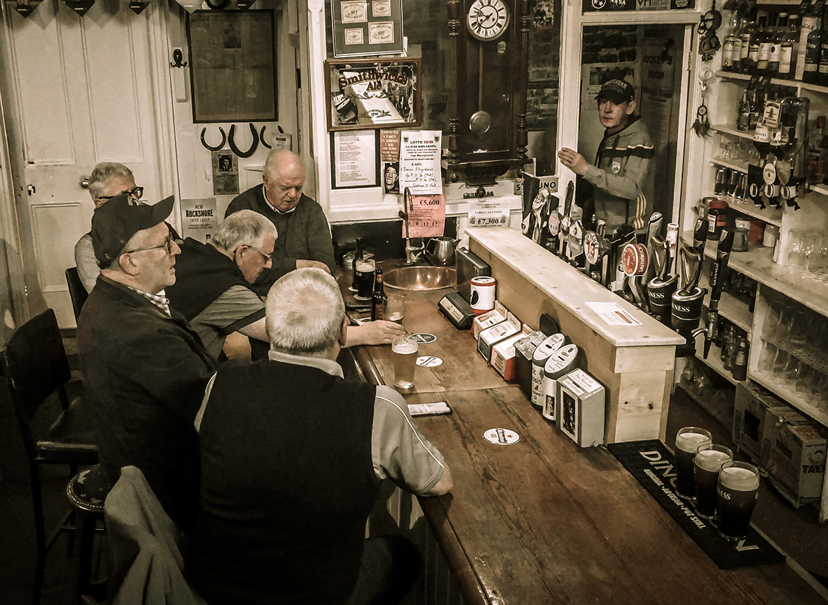 Irishmen gathered around the bar at Curran's Pub in Dingle, Ireland. File photo ©2020, Mark Gillespie/CaskStrength Media.