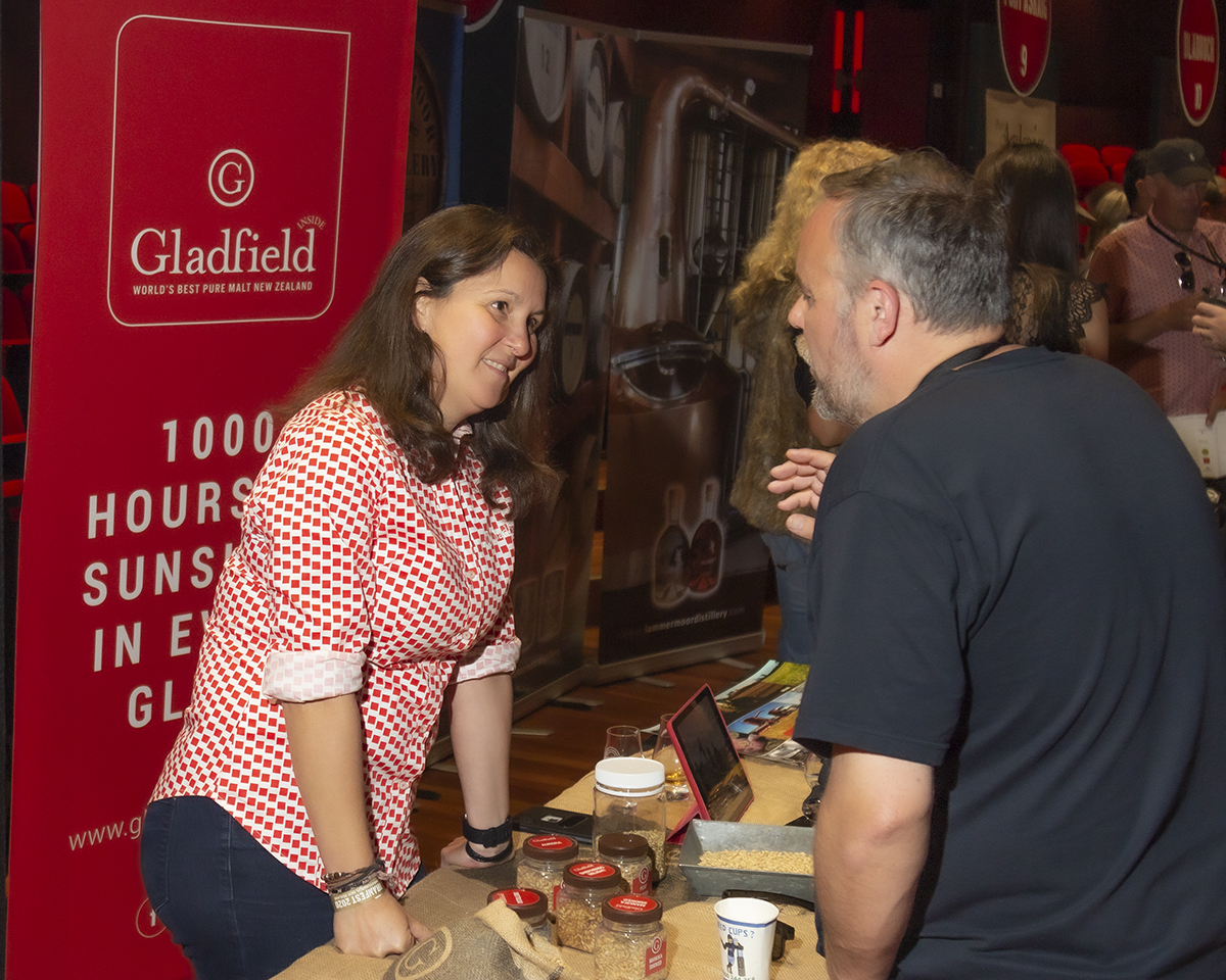 Gabi Mitchell of Gladfield Malt talks with a whisky lover during the recent DramFest 2020 in Christchurch, New Zealand. Photo ©2020, Mark Gillespie/CaskStrength Media.