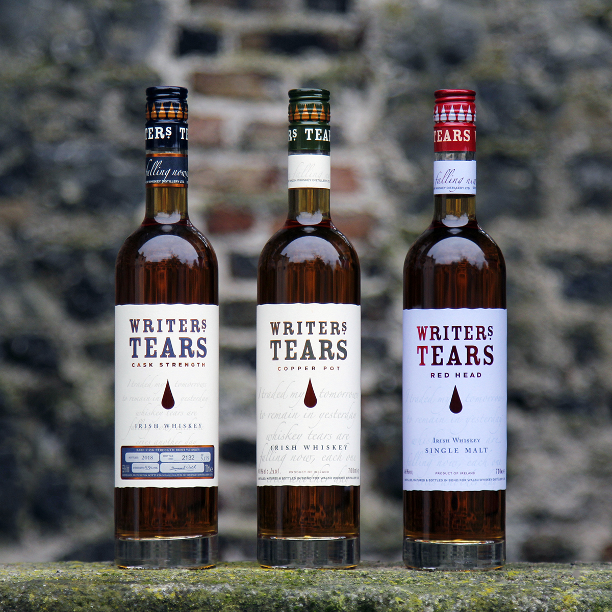 The Writers' Tears range of whiskies lined up along a stone wall in County Carlow, Ireland. Photo ©2020, Mark Gillespie/CaskStrength Media.