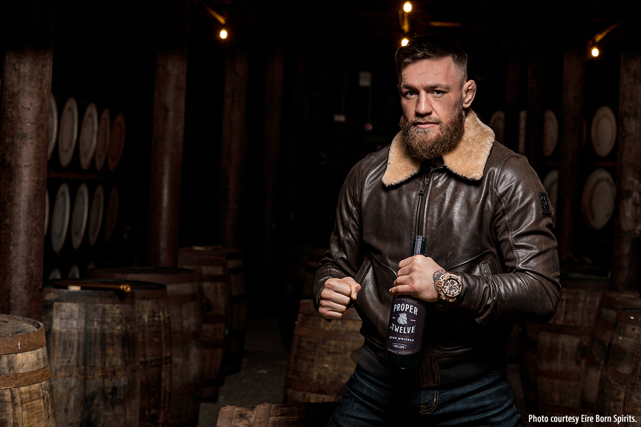 Former MMA champion Conor McGregor poses with a bottle of Proper No. Twelve Irish Whiskey. Image courtesy Eire Born Spirits.