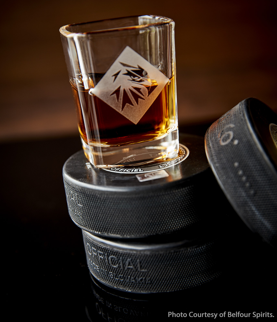 A Belfour Spirits whiskey glass with hockey pucks. Image courtesy Belfour Spirits.