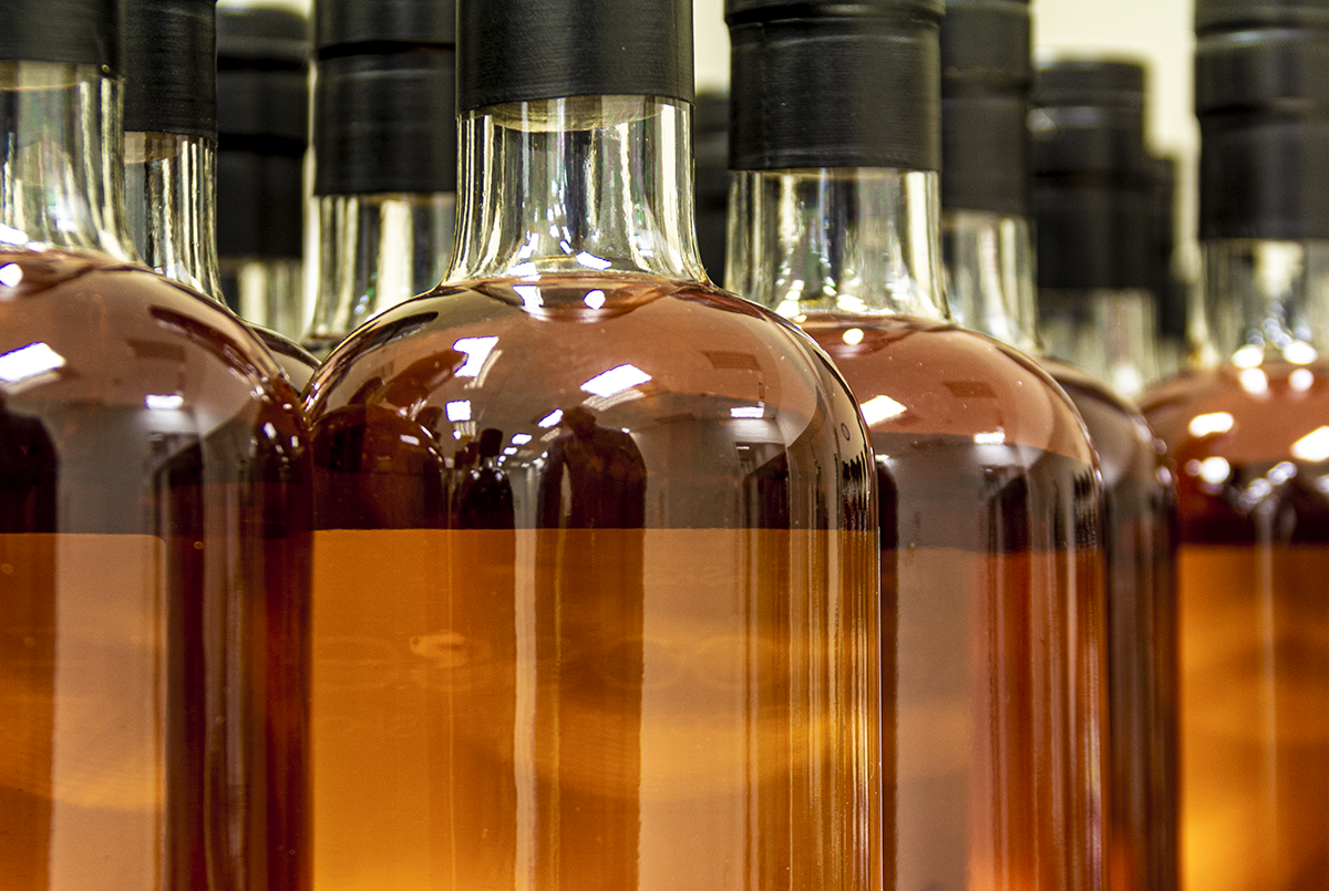 Scotch Whisky bottles awaiting labeling on a bottling line. File photo ©2021, Mark Gillespie/CaskStrength Media.