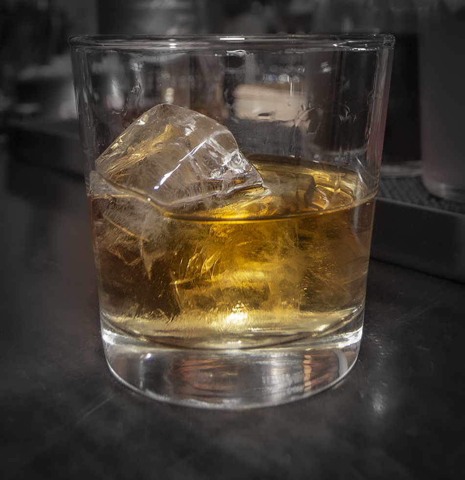 A glass of whiskey sitting on a bar. Photo ©2021, Mark Gillespie/CaskStrength Media.