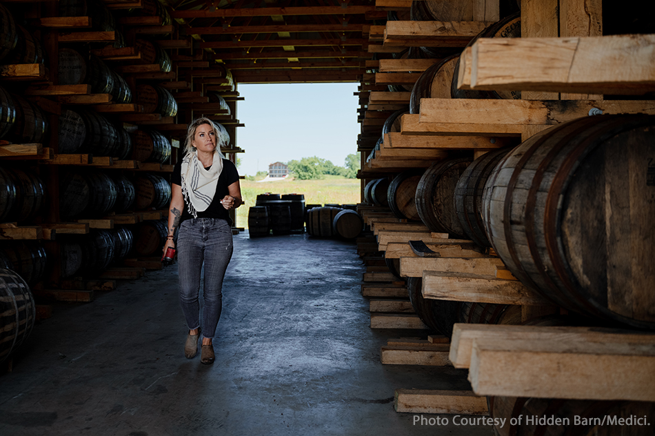 Jackie Zykan walks through a warehouse at Neeley Family Distillery in Kentucky. Image courtesy Hidden Barn Whiskey/Medici.