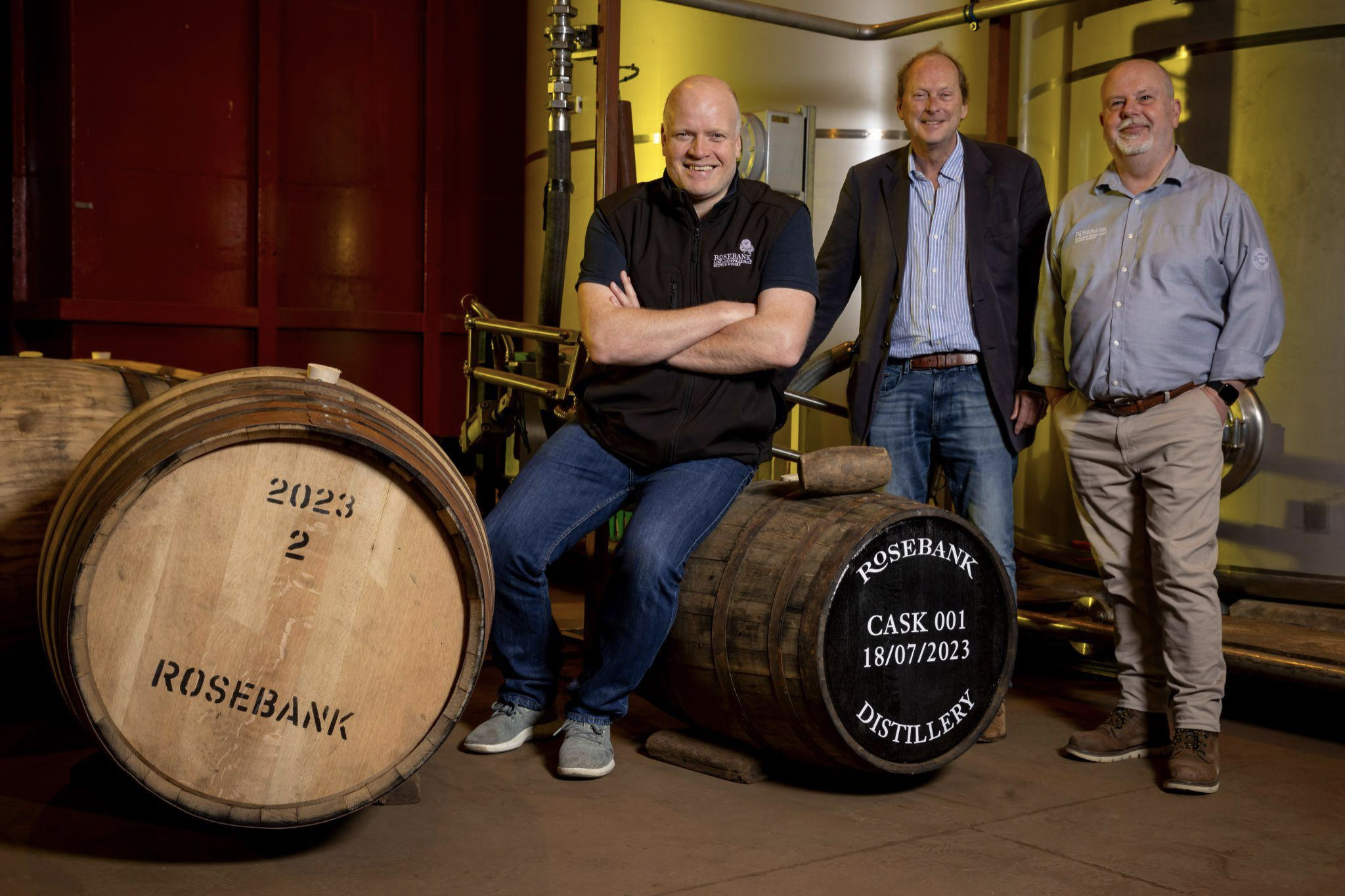Gordon Dundas, Leonard Russell, and Malcolm Rennie of Ian Macleod Distillers with the first cask of Rosebank filled in more than 30 years. Image courtesy Ian Macleod Distillers.